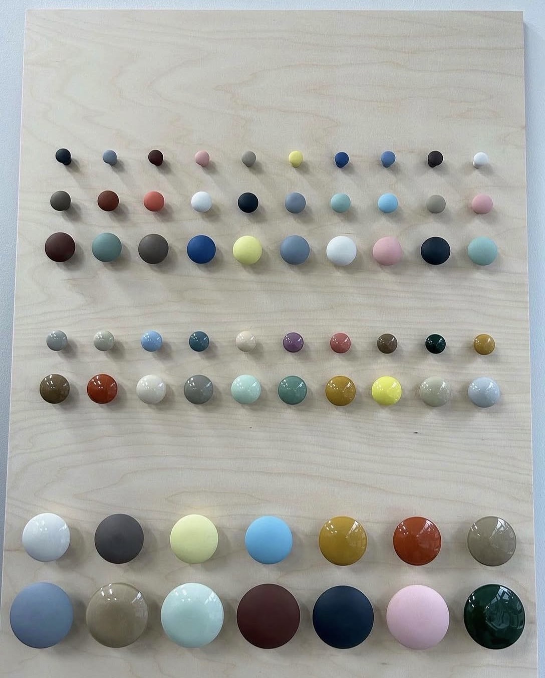 a range of anne black porcelain knobs in different sizes and glaze colours