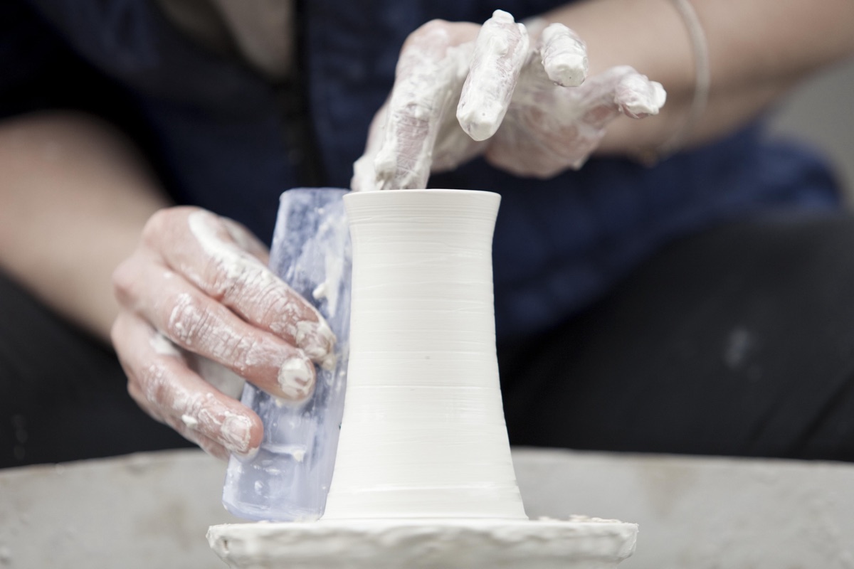 a jug being thrown by hand